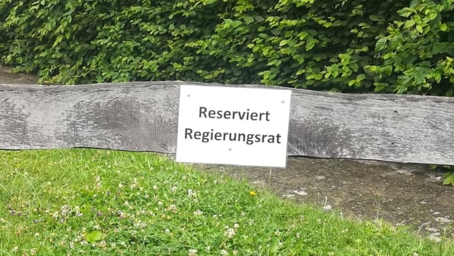 Ein Schild an einer Holzlatte mit der Aufschrift: Reserviert Regierungsrat Ein Schild an einer Holzlatte mit der Aufschrift: Reserviert Regierungsrat