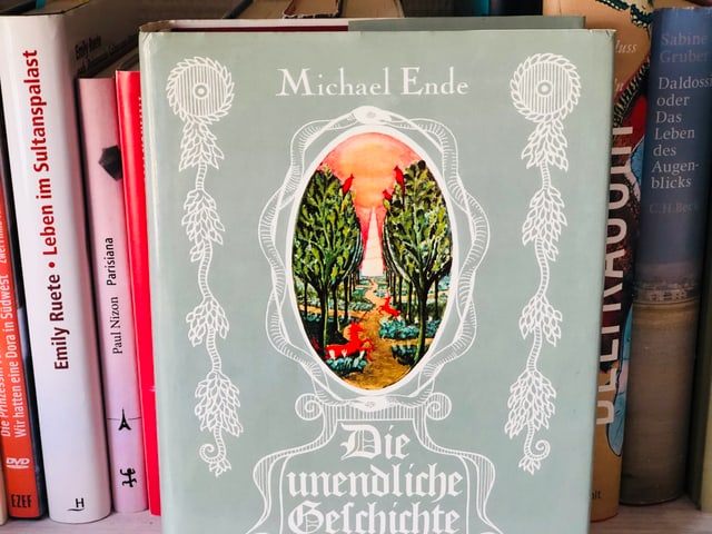 Das Buch Michael Ende: «Die unendliche Geschichte» liegt auf einem Bücherregal Das Buch Michael Ende: «Die unendliche Geschichte» liegt auf einem Bücherregal