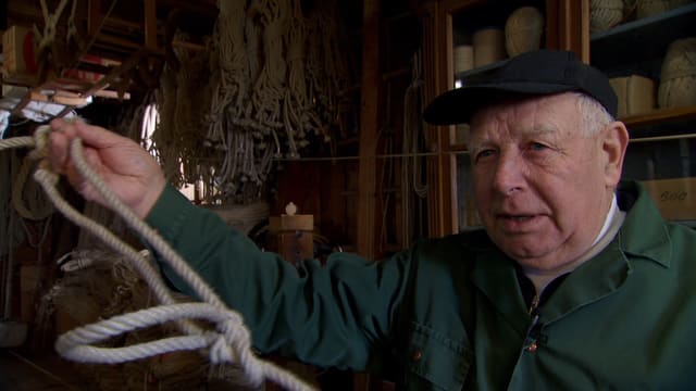 Ein alter Seilermeister mit einem Strick in der Hand. Ein alter Seilermeister mit einem Strick in der Hand.
