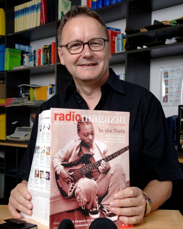Witschi hält Zeitschrift «Radiomagazin» in Händen. Witschi hält Zeitschrift «Radiomagazin» in Händen.