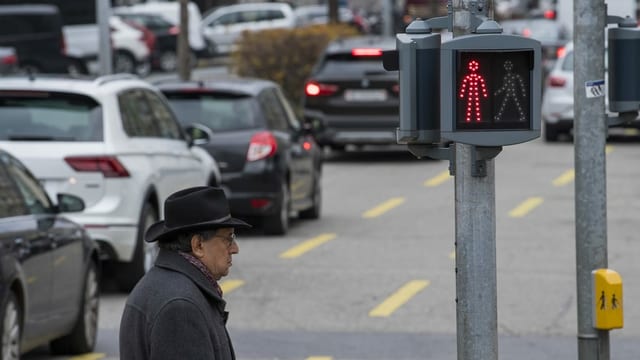 Ein Mann steht neben einer Autostrasse. Ein Mann steht neben einer Autostrasse.