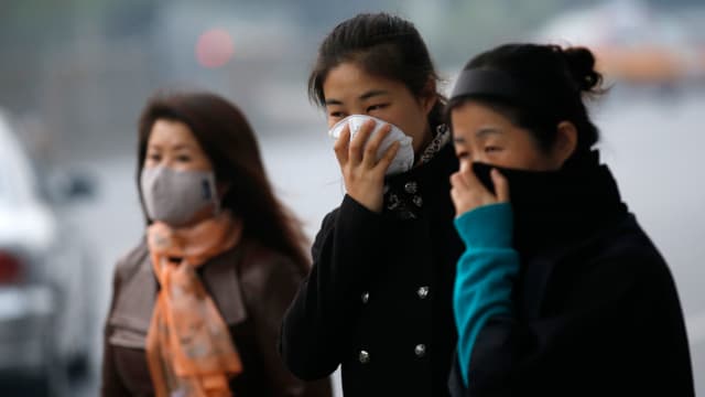 Chinesinnen mit Atemschutzmasken Chinesinnen mit Atemschutzmasken