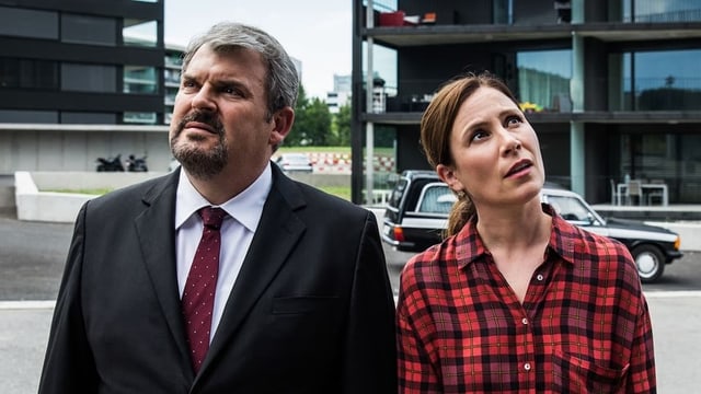 Ein Mann und eine Frau stehen nebeneinander, gucken nach oben. Ein Mann und eine Frau stehen nebeneinander, gucken nach oben.