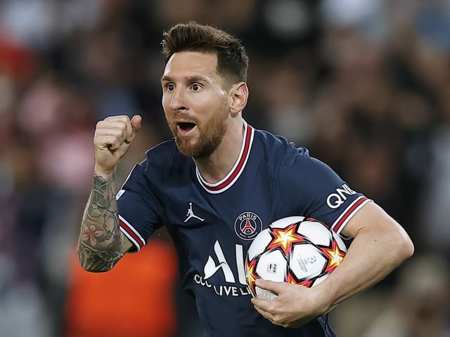 Lionel Messi jubelt mit dem Ball unter dem linken Arm.