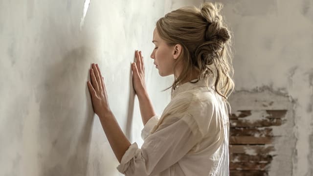 Frau mit geschlossenen Augen hält Hände gegen eine Wand Frau mit geschlossenen Augen hält Hände gegen eine Wand
