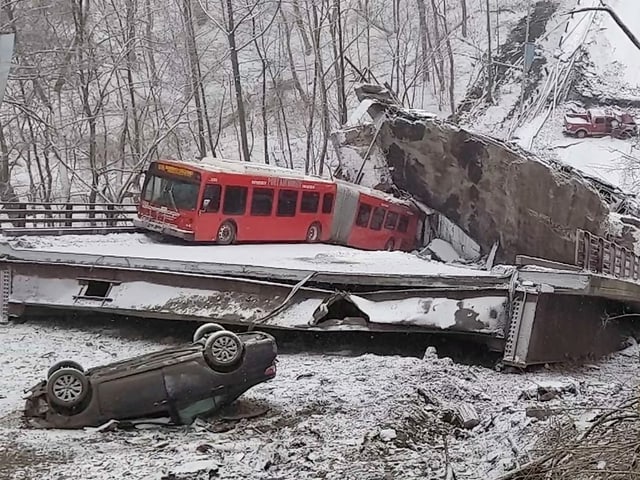 There is a regular bus and a car in front of the bridge demolition site.