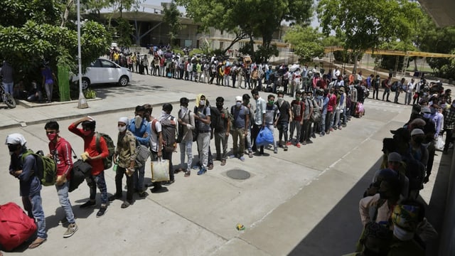 Migrant workers stand in line. Migrant workers stand in line.