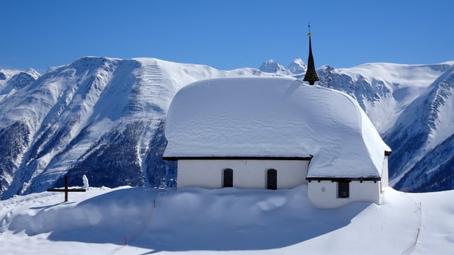 Tief verschneite Kirhce auf der Bettmeralp vor stahlblauem Himmel. Tief verschneite Kirhce auf der Bettmeralp vor stahlblauem Himmel.