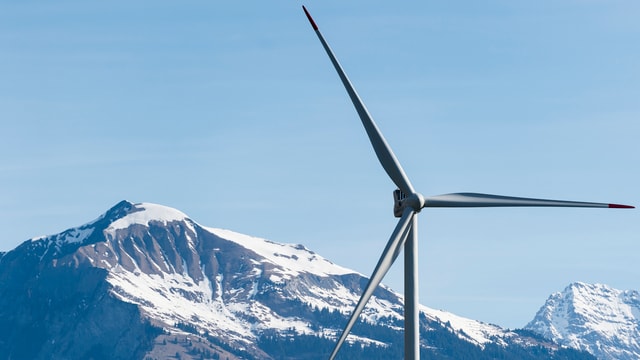 Windrad vor einem verschneiten Berg Windrad vor einem verschneiten Berg