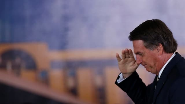 Bolsonaro grüsst mit der Hand am Kopf. Bolsonaro grüsst mit der Hand am Kopf.