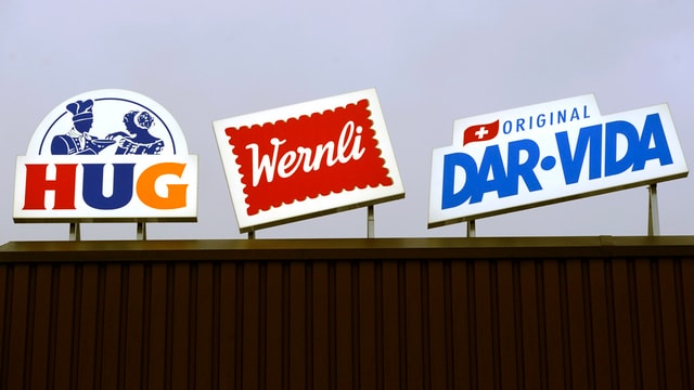 Die Werbeschilder von Hug, Wernli und Dar-Vida nebeneinander auf einem Dach. Die Werbeschilder von Hug, Wernli und Dar-Vida nebeneinander auf einem Dach.
