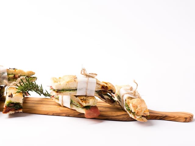 Sandwiches nebeneinander auf einem Holzbrett Sandwiches nebeneinander auf einem Holzbrett