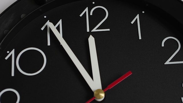 Ein Uhr zeigt 5 vor 12 Uhr an. Ein Uhr zeigt 5 vor 12 Uhr an.