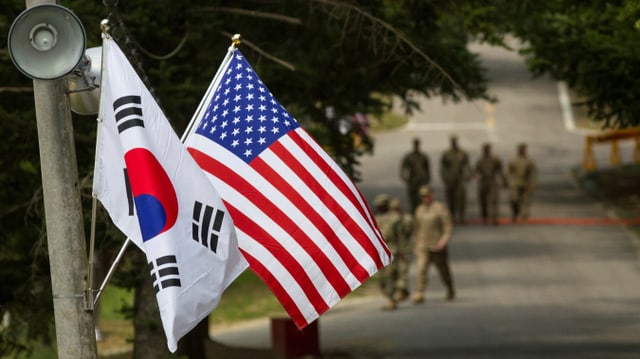 Südkoreanische und US-Flagge, Soldaten im Hintergrund Südkoreanische und US-Flagge, Soldaten im Hintergrund