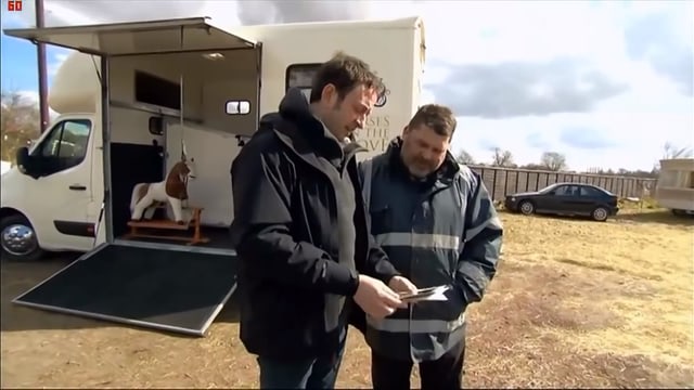 BBC Moderator Matt Allwright im Gespräch mit Pferdehändler vor Pferdetransporter mit Schaukelpferd BBC Moderator Matt Allwright im Gespräch mit Pferdehändler vor Pferdetransporter mit Schaukelpferd