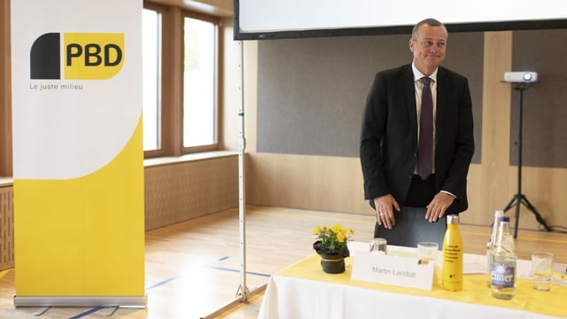 Landolt steht hinter einem Tisch, daneben das gelbe BDP-Logo. Landolt steht hinter einem Tisch, daneben das gelbe BDP-Logo.