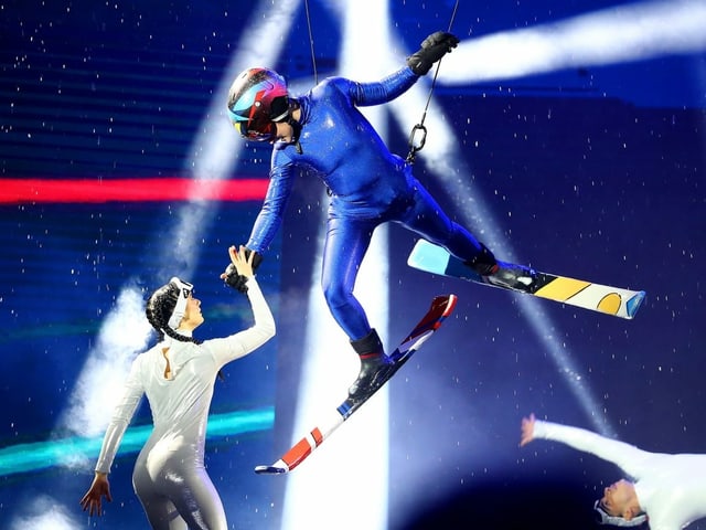 Skifahrer schwebt an Seilen vom Himmel