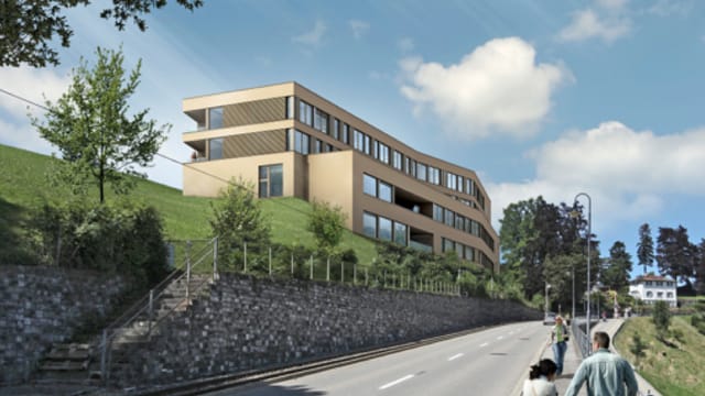 Neubau der Berit-Klinik: Ein sandfarbiges Gebäude oberhalb einer Strasse. Neubau der Berit-Klinik: Ein sandfarbiges Gebäude oberhalb einer Strasse.