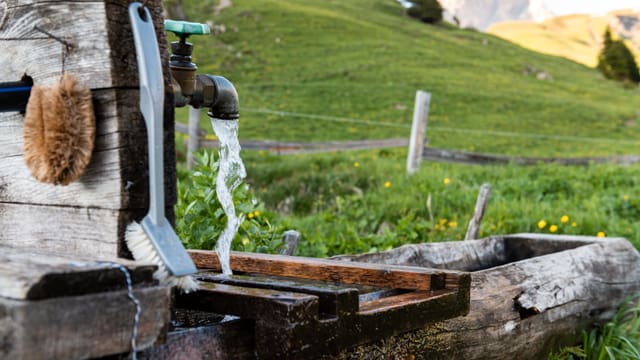 Ein Brunnen. Wasser läuft aus dem Wasserhahnen. Ein Brunnen. Wasser läuft aus dem Wasserhahnen.