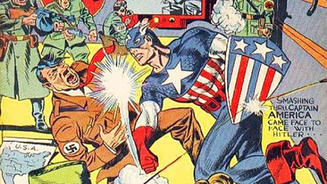 Eine Comic-Zeichnung: Ein Mann in engem Anzug und mit Maske verpasst Hitler einen Schlag ins Gesicht. Eine Comic-Zeichnung: Ein Mann in engem Anzug und mit Maske verpasst Hitler einen Schlag ins Gesicht.