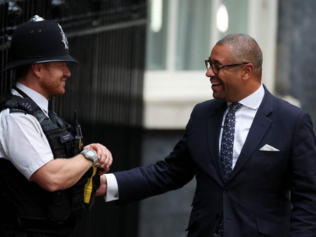 James smartly talks to a police officer and they both laugh