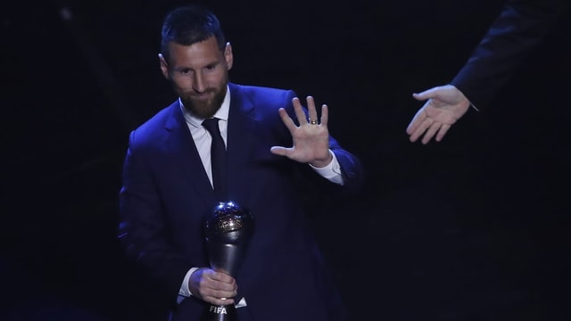 Purtet da Lionel Messi cun il premi enta maun. Purtet da Lionel Messi cun il premi enta maun.