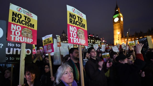 Demonstranten halten Anti-Trump-Plakate in die Luft vor dem Parlament in London. 
