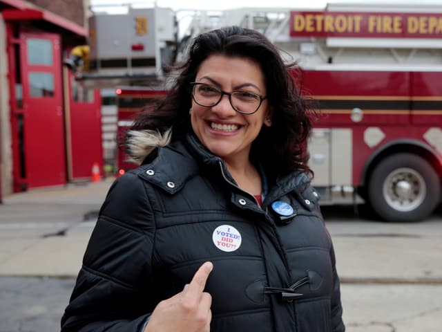 Frau zeigt auf "I voted"-Button