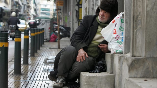 Ein Obdachloser sitzt in einem Hauseingeng. Ein Obdachloser sitzt in einem Hauseingeng.