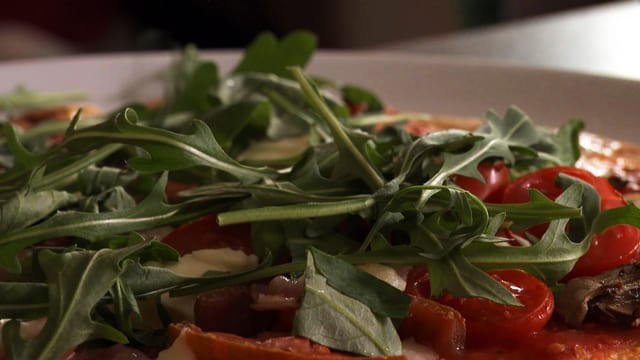 Pizza mit Ruccola und Tomaten Pizza mit Ruccola und Tomaten