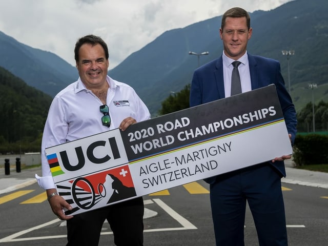 Alexandre Debons und Grégory Devaud vom OK der Heim-WM mit einem Banner, auf dem Aigle-Martigny steht Alexandre Debons und Grégory Devaud vom OK der Heim-WM mit einem Banner, auf dem Aigle-Martigny steht