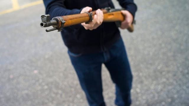 Ein Mann mit einem Karabiner in der Hand. Ein Mann mit einem Karabiner in der Hand.