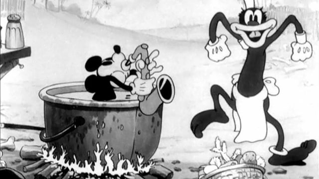 Eine Maus im Kochtopf über einem Feuer spielt Saxophon. Eine Maus im Kochtopf über einem Feuer spielt Saxophon.