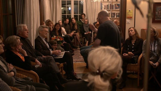 Ein Mann steht in einem Wohnzimmer. Ein Mann steht in einem Wohnzimmer.