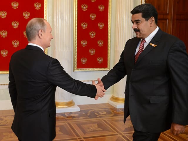 Nicolas Maduro und Wladimir Putin reichen sich die Hand.