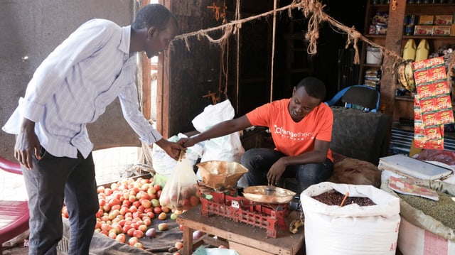 Ein Mann im Flüchtlingslager Dadaab in Kenia kauft Tomaten an einem Stand. Ein Mann im Flüchtlingslager Dadaab in Kenia kauft Tomaten an einem Stand.