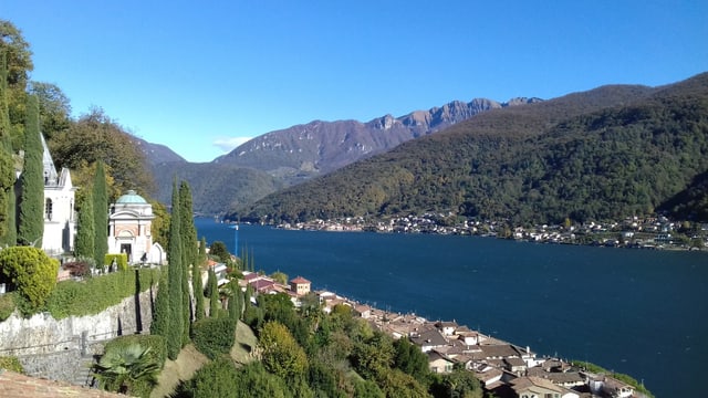 Blick über den tiefblauen Luganersee Richtung Norden. Der Himmel ist wolkenlos und ebenfalls tiefblau. Blick über den tiefblauen Luganersee Richtung Norden. Der Himmel ist wolkenlos und ebenfalls tiefblau.