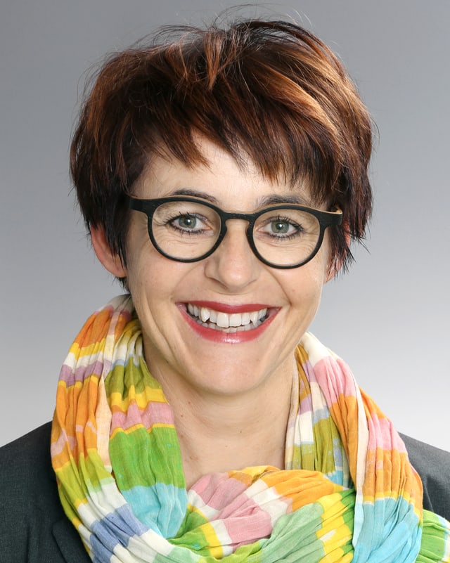 Portrait einer lächelnden Frau mit farbigem Schal Portrait einer lächelnden Frau mit farbigem Schal