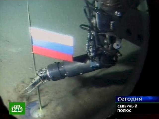 Ein Roboterarm setzt russische Flagge auf den Meeresgrund.