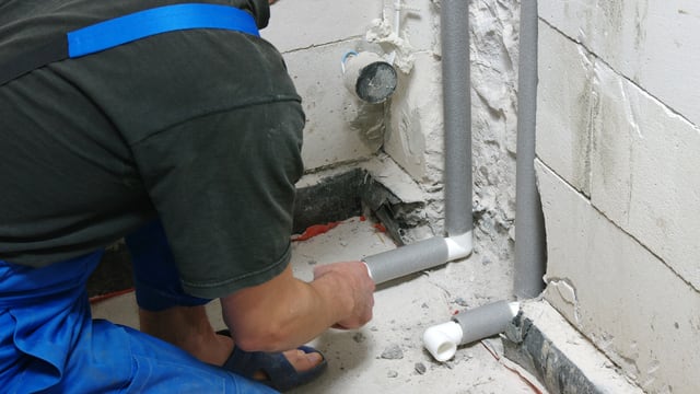Arbeiter installiert Rohre. Arbeiter installiert Rohre.