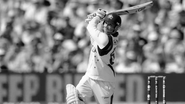Hughes beim Spielen, er schlägt einen Ball. Das Bild ist in schwarz-weiss gehalten. Hughes beim Spielen, er schlägt einen Ball. Das Bild ist in schwarz-weiss gehalten.