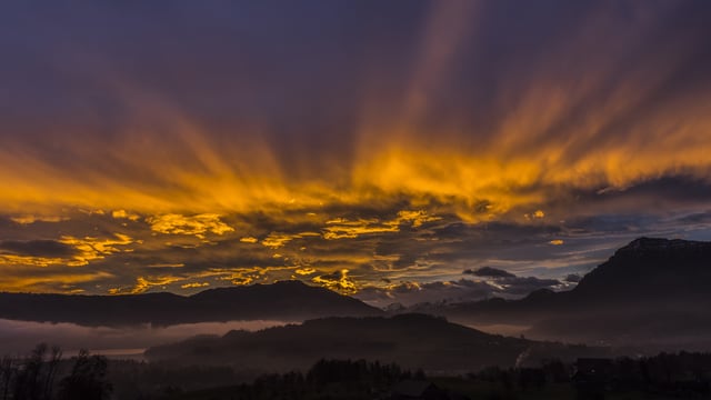 Blick über den Chiemen am Zugersee, Richtung Berge. Wildes Strahlenmeer über den Alpen. Blick über den Chiemen am Zugersee, Richtung Berge. Wildes Strahlenmeer über den Alpen.