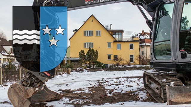 Ein Bagger auf einer Baustelle: Im Vordergrund das Aargauer Wappen (Montage) Ein Bagger auf einer Baustelle: Im Vordergrund das Aargauer Wappen (Montage)