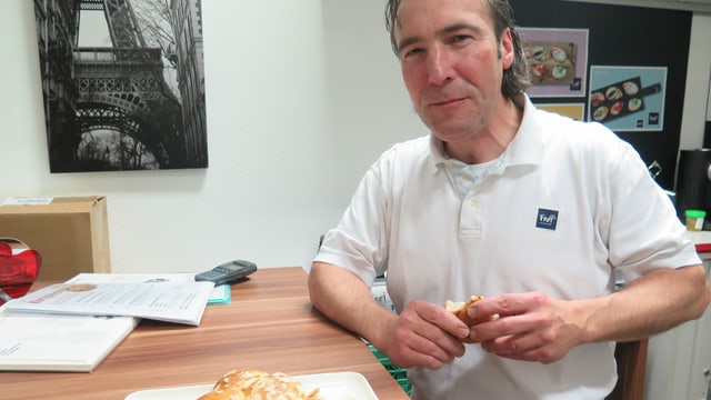 Der Chefbäcker beim Essen eines Königskuchens Der Chefbäcker beim Essen eines Königskuchens