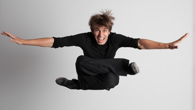Ein Mann mit angezogenen Beinen springt. Ein Mann mit angezogenen Beinen springt.