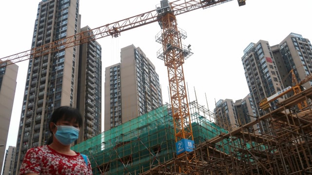 Woman in front of construction site Woman in front of construction site