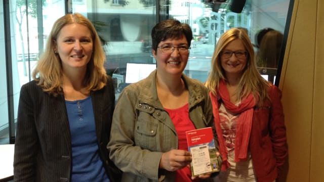 La victura da la concurrenza Sandra Carigiet da Sumvitg, ensemen cun Claudia Cathomen da RTR ed Yvonne Dünser da la Viafier Retica. La victura da la concurrenza Sandra Carigiet da Sumvitg, ensemen cun Claudia Cathomen da RTR ed Yvonne Dünser da la Viafier Retica.