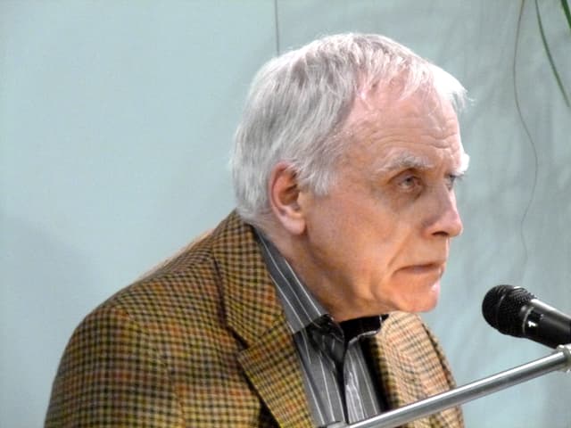 Moshe Kahn über ein Mikrofon gebeugt, vom alter gezeichnet. Moshe Kahn über ein Mikrofon gebeugt, vom alter gezeichnet.