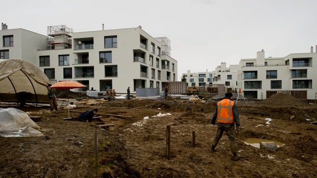 Arbeiter auf einer Baustelle in einem Wohnquartier. Arbeiter auf einer Baustelle in einem Wohnquartier.