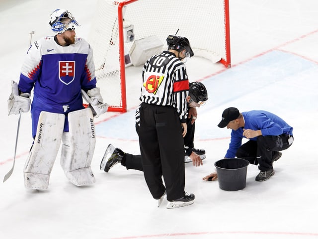Der Eismeister flickt während einer Partie das Eis. Der Eismeister flickt während einer Partie das Eis.
